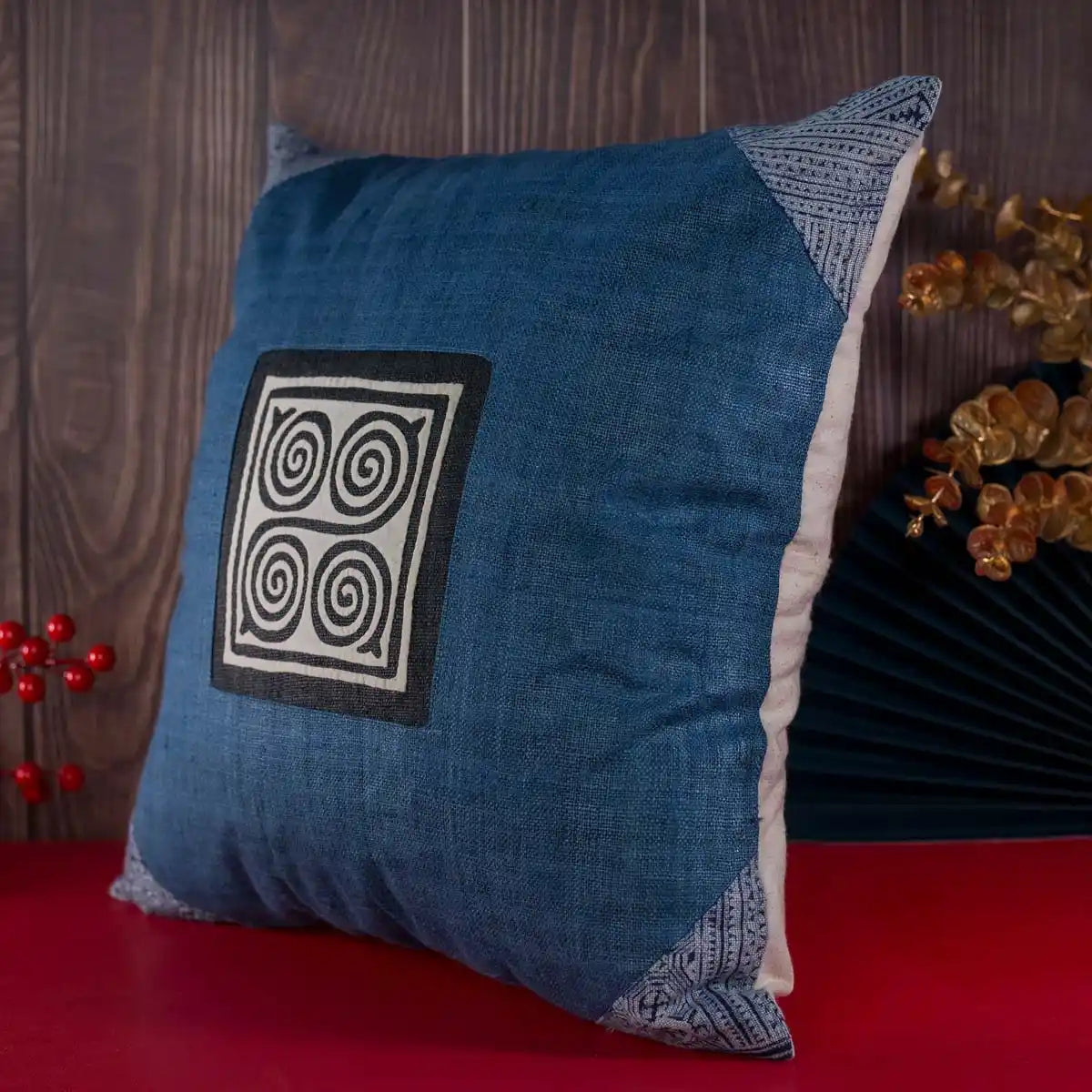 Vindigo blue hemp cushion cover on sofa with hand-embroidered spiral motif