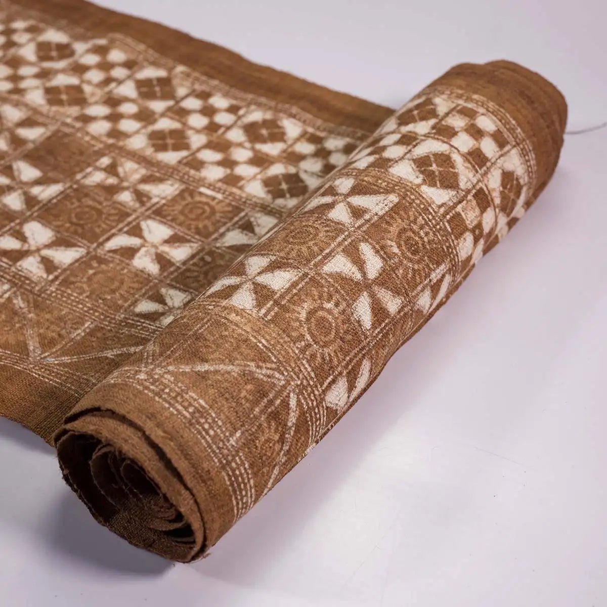 Vindigo brown ethnic geometric fabric roll partially rolled