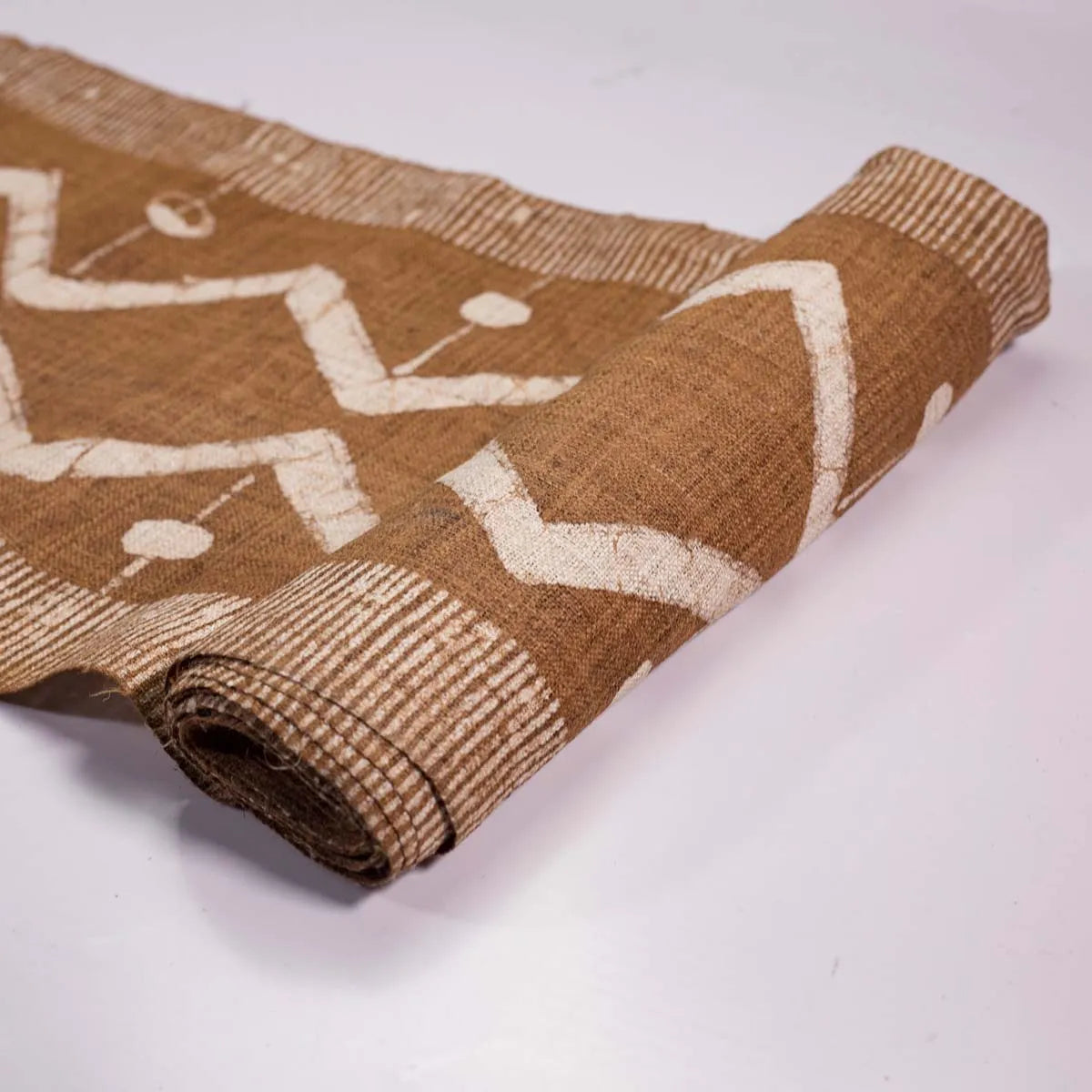 Vindigo brown tribal zigzag fabric roll partially rolled view