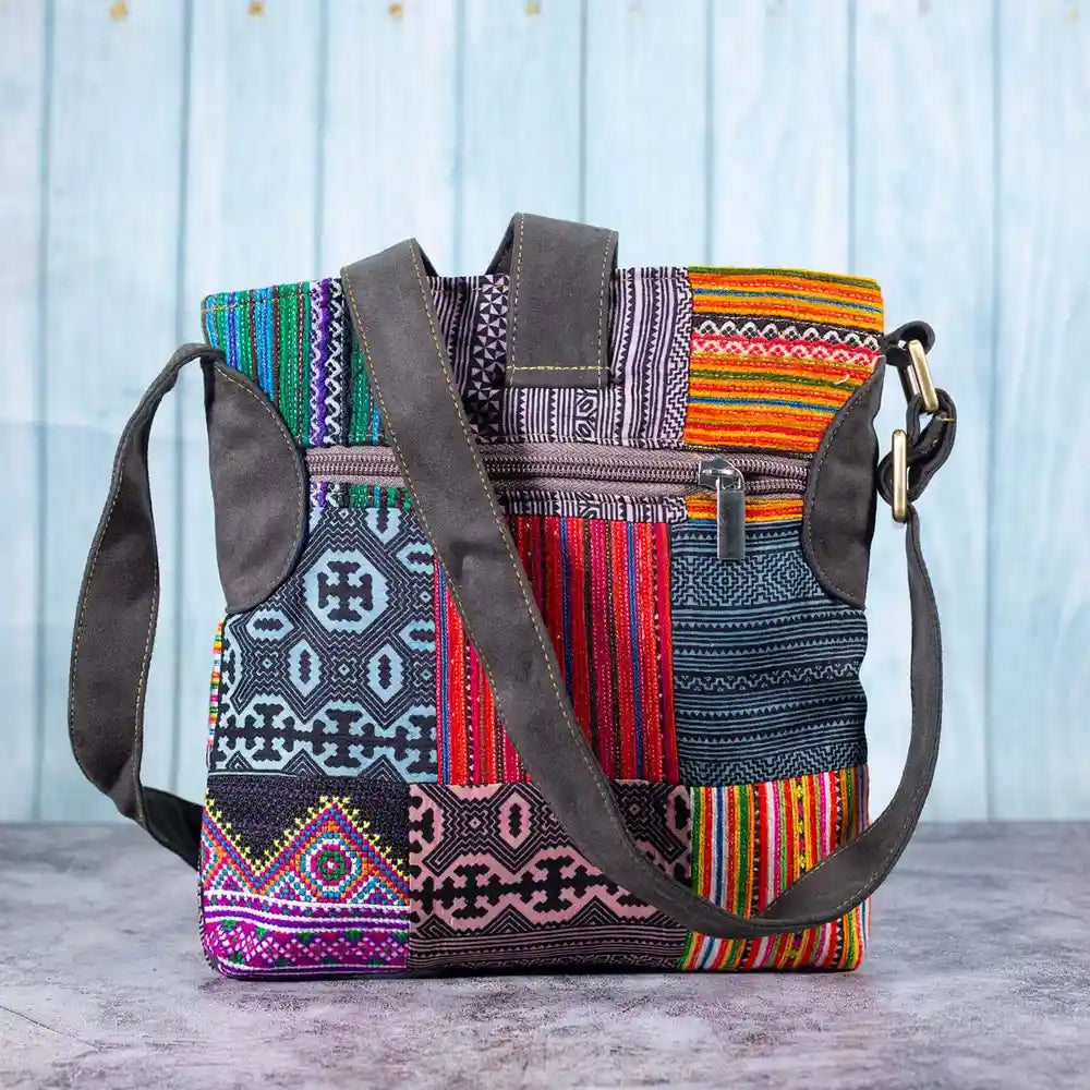 Vindigo crossbody bag front view displaying H’mong patchwork in vibrant colors