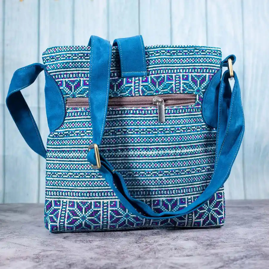 Vindigo blue embroidered crossbody bag back view with zipper pocket and geometric pattern