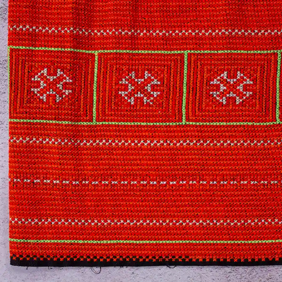 Vindigo red hemp fabric roll with tribal embroidery pattern front view