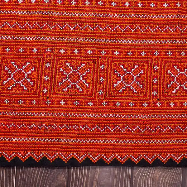 Vindigo red hemp fabric with tribal embroidery flat laid front view