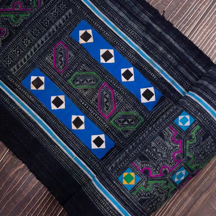 Vindigo black embroidered fabric roll with tribal blue and pink motifs