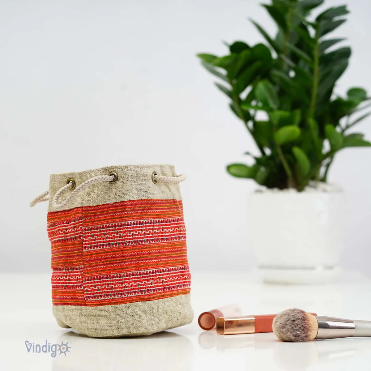 Vindigo orange tribal hemp mini pouch styled with green plant