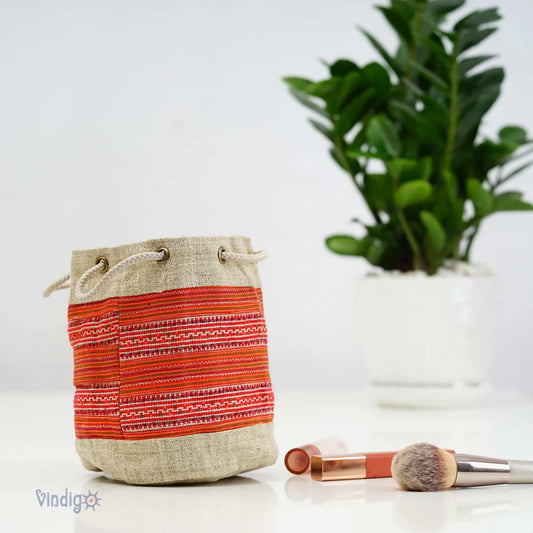 Vindigo orange tribal hemp mini pouch styled with green plant