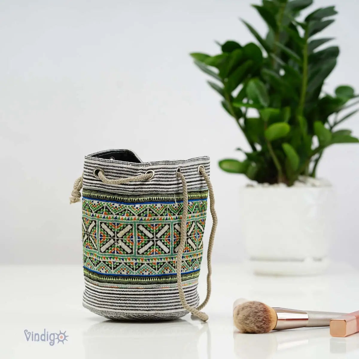 Vindigo green hemp tribal mini pouch styled beside indoor plant