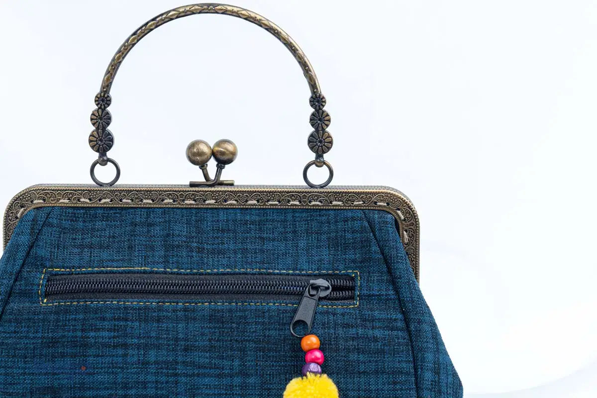 Vindigo handbag close-up of copper handle and back zipper pocket