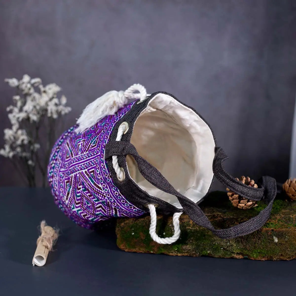 Close-up detail of Vindigo purple hemp floral embroidery pattern