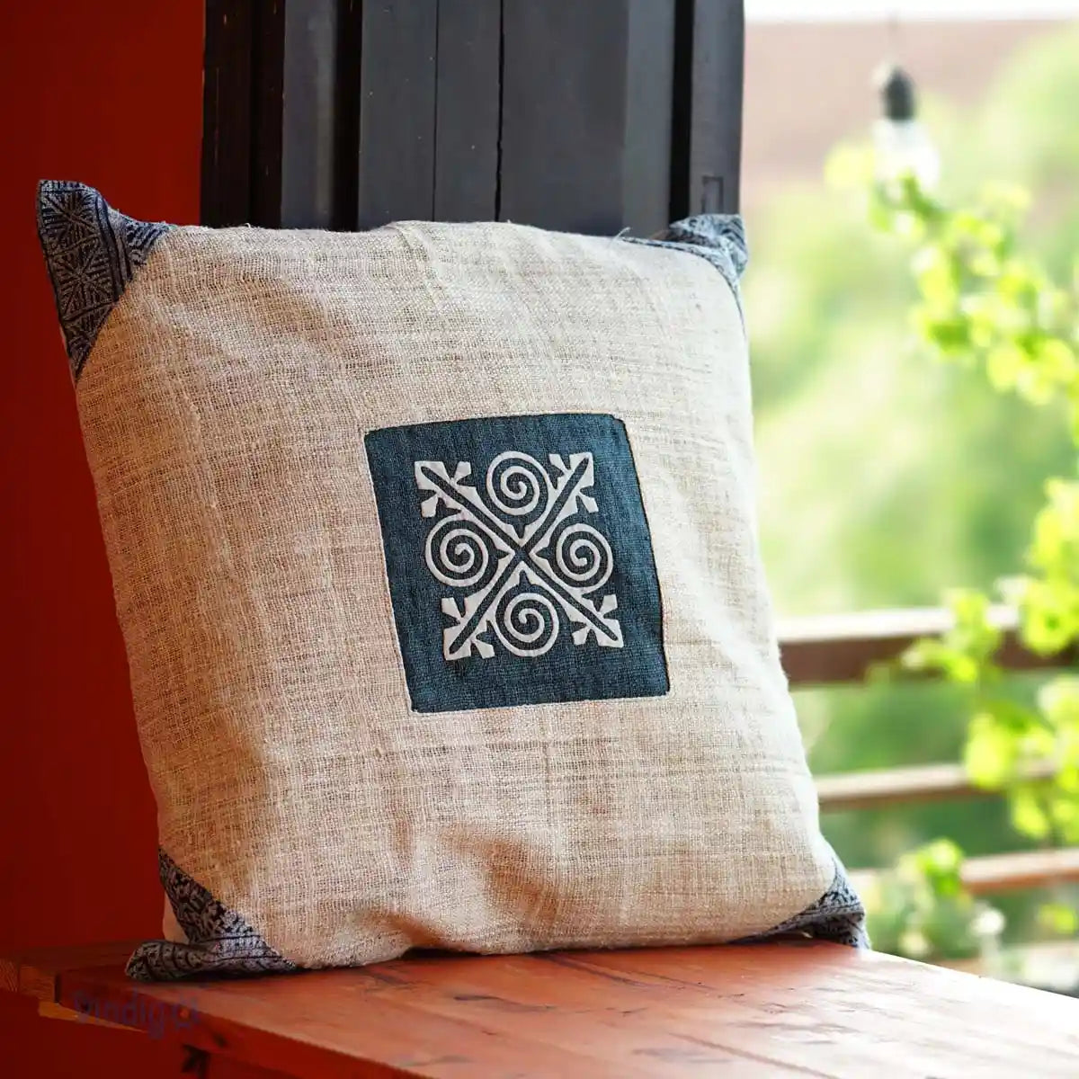 Indigo batik patch cushion leaning on window frame