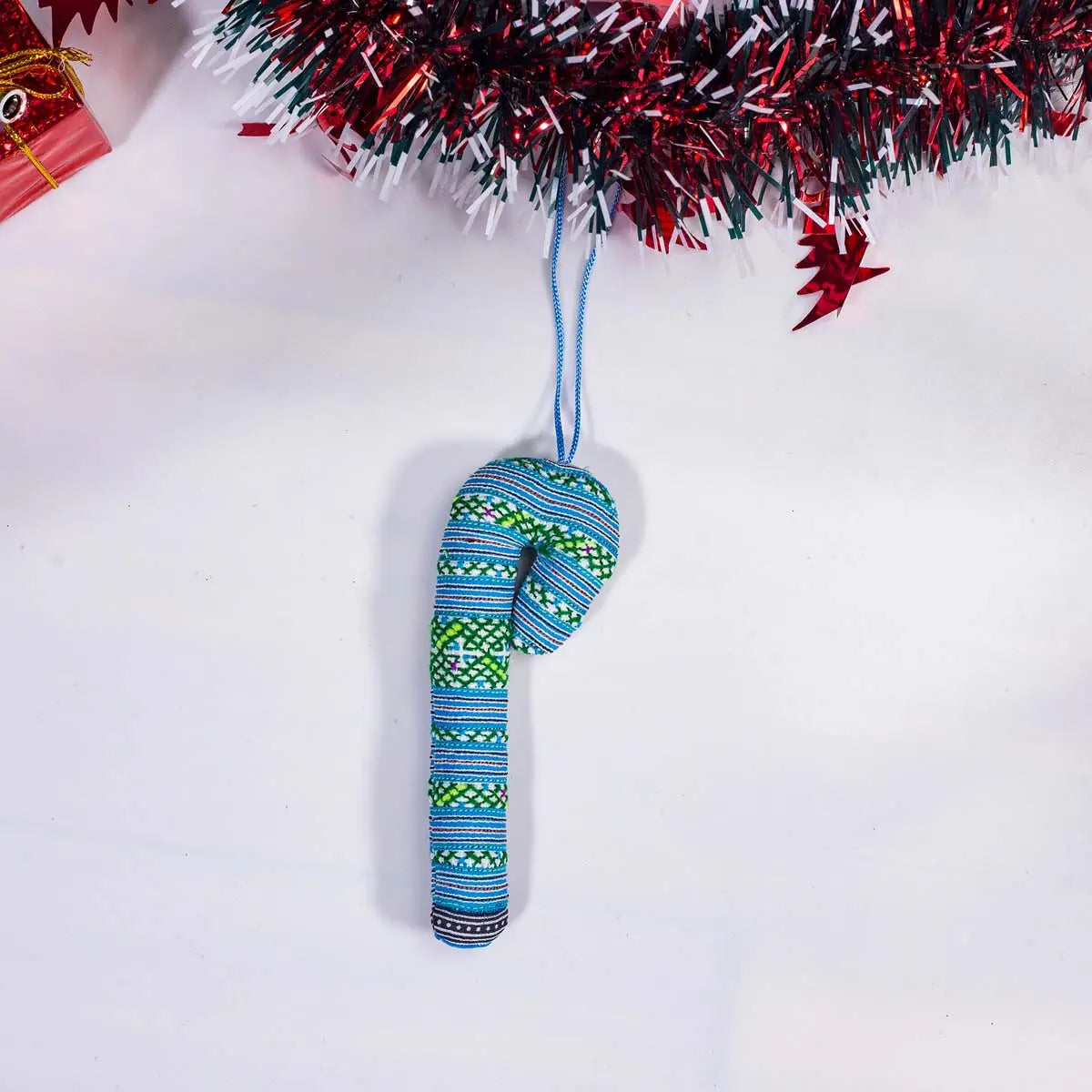 Vindigo green tribal embroidered candy cane-shaped ornament hanging front view