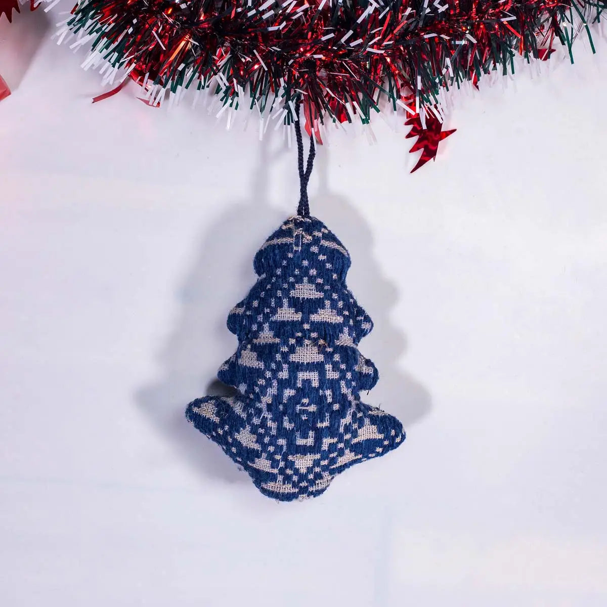 Vindigo blue tribal embroidered Christmas tree-shaped ornament under garland