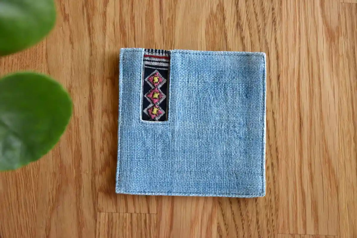 Close-up of handwoven tribal fabric detail on denim coaster