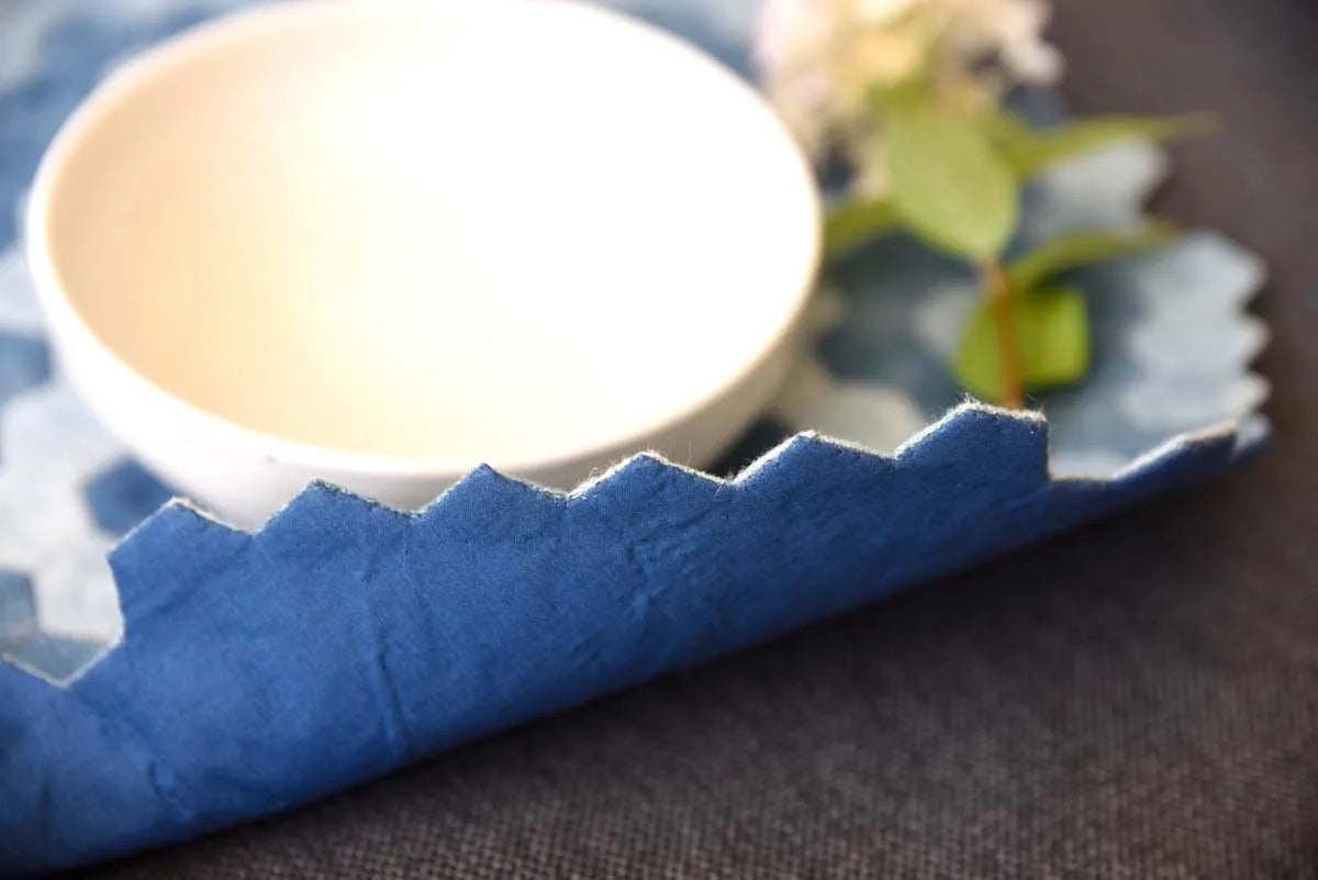Edge stitching detail on blue denim hexagon placemat