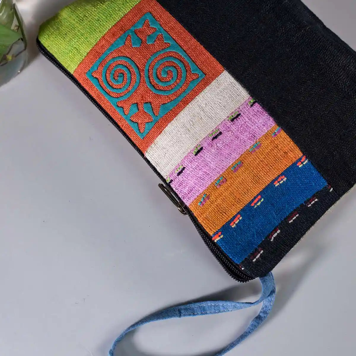 Vindigo hemp cosmetic bag side angle featuring vivid spiral embroidery