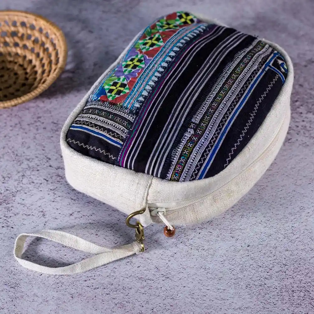 Vindigo hemp cosmetic bag flat lay showing colorful ethnic embroidery on top panel