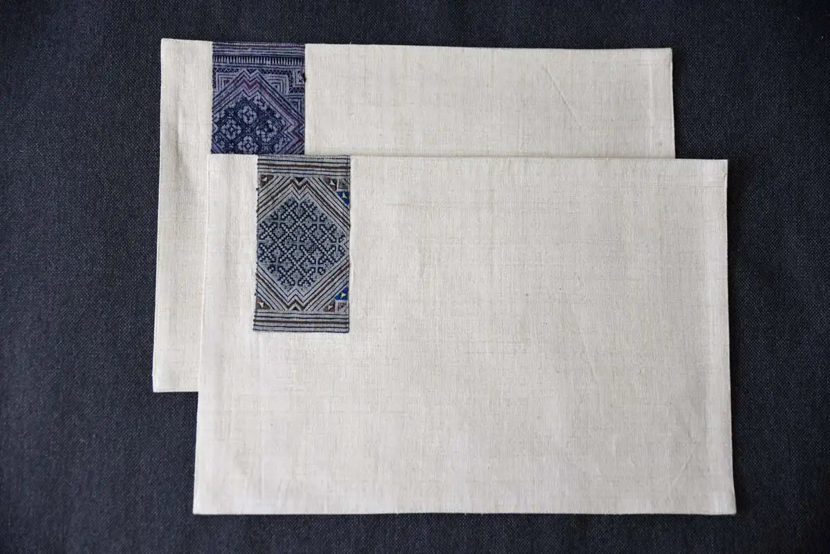 Flatlay of cream hemp placemat and napkin set with indigo accent