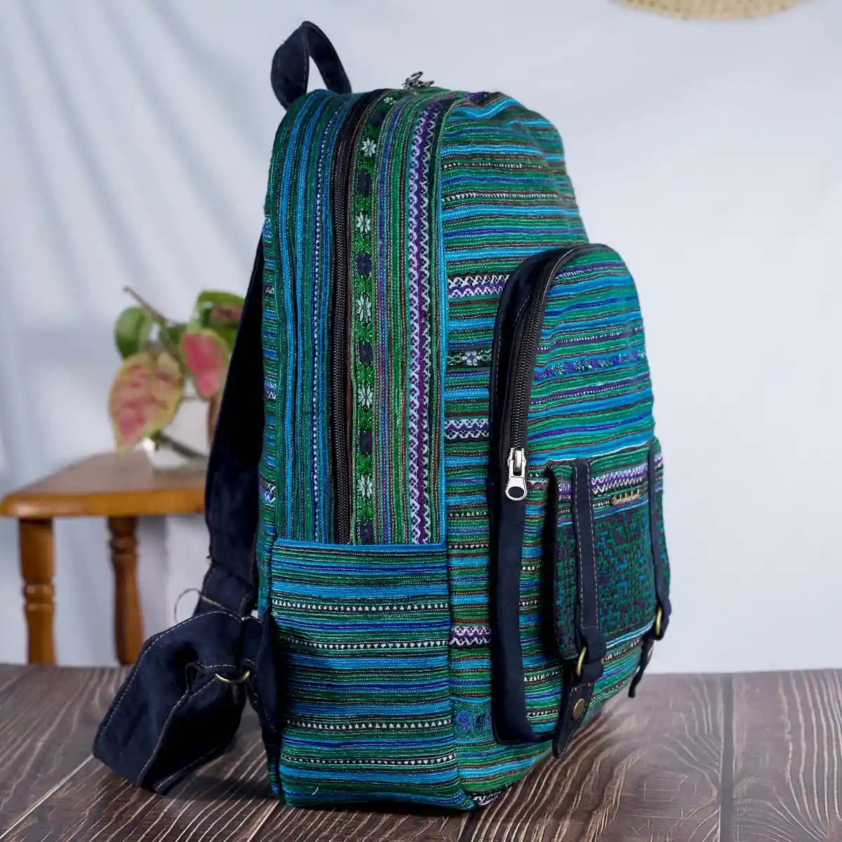 Vindigo green embroidered backpack side view showing compartments