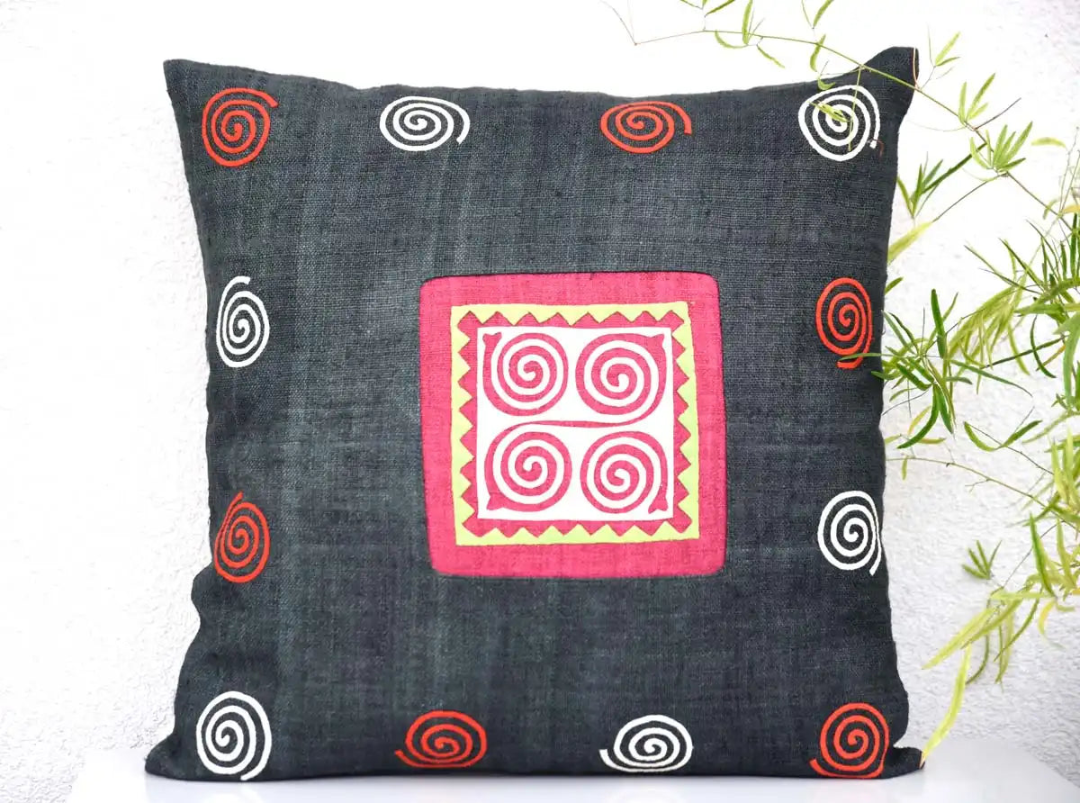 Front view of black cushion cover with colorful spiral accents