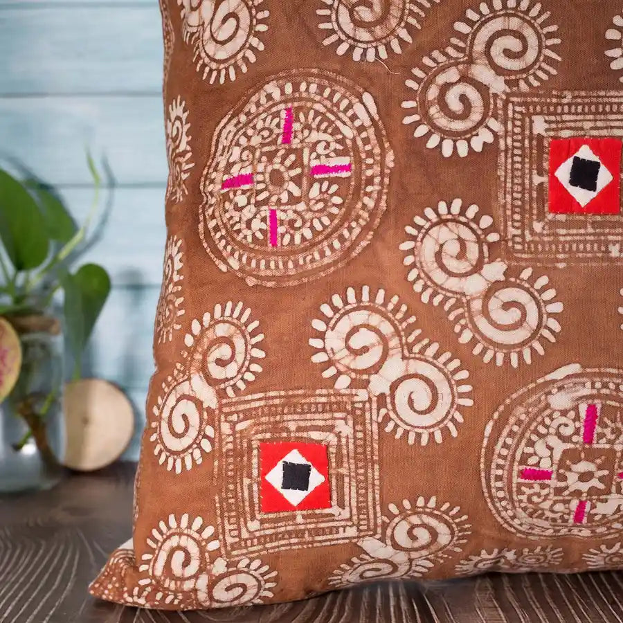 Vindigo brown cushion cover detail showing red square motif and spirals