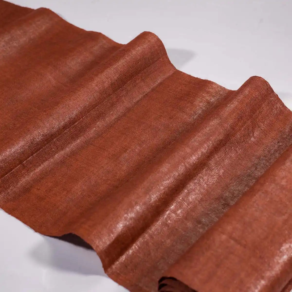 Vindigo earthy orange hemp fabric roll close-up view