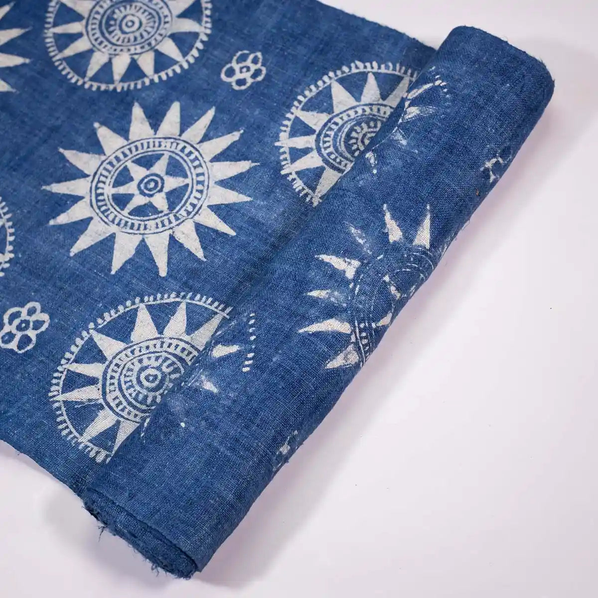 Vindigo indigo fabric roll with sunflower motif, rolled edge view