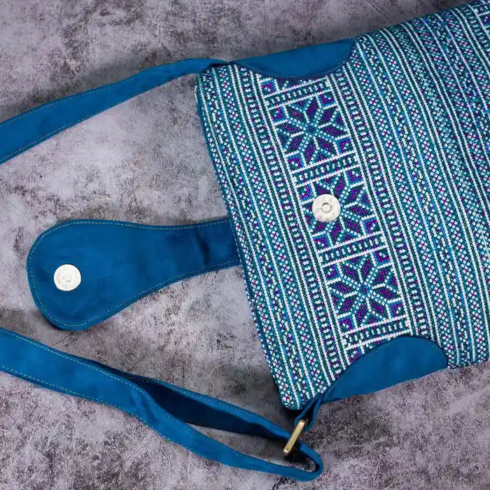 Vindigo blue embroidered crossbody bag flat lay showing magnetic flap and full embroidery