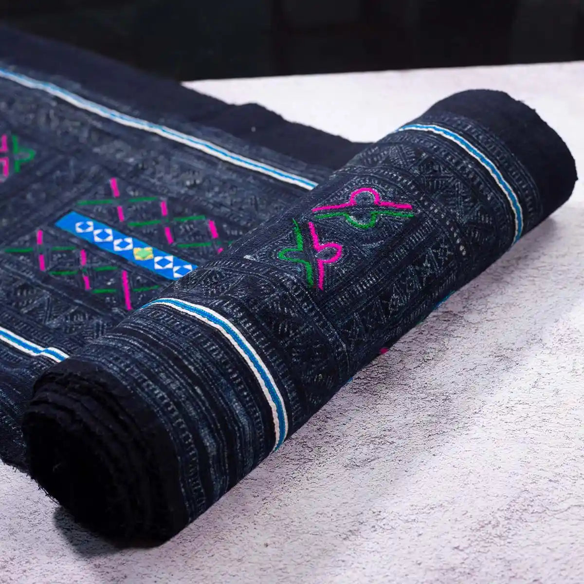 Vindigo black fabric roll with vintage panel embroidery, rolled edge