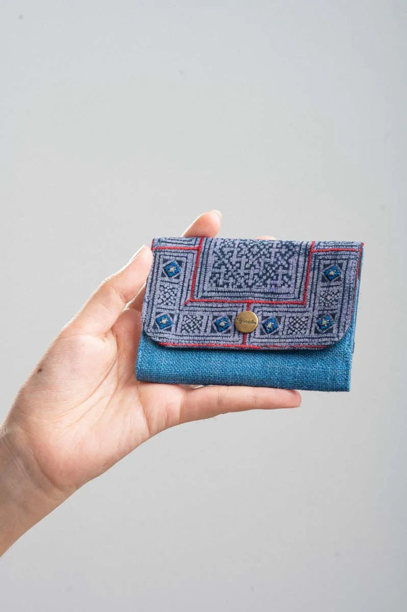 Vindigo hand-holding blue batik wallet with geometric embroidery