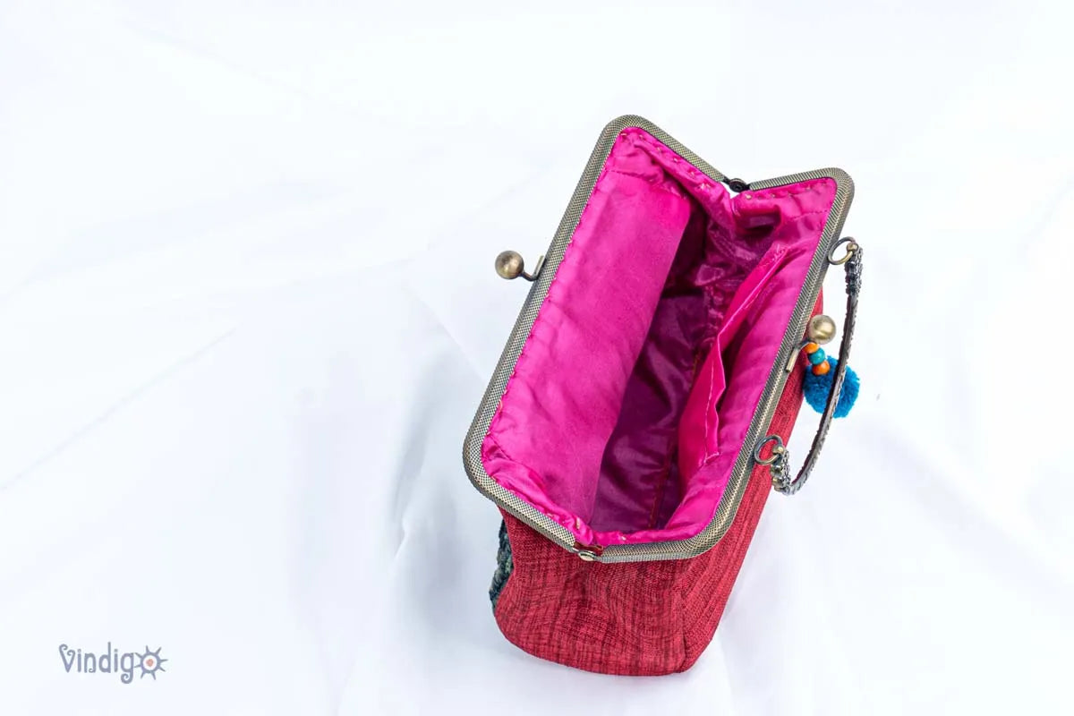 Vindigo red embroidered handbag open top showing bright pink inner lining