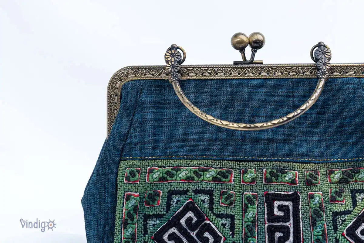 Vindigo copper frame handbag with carved handle and embroidered fabric detail