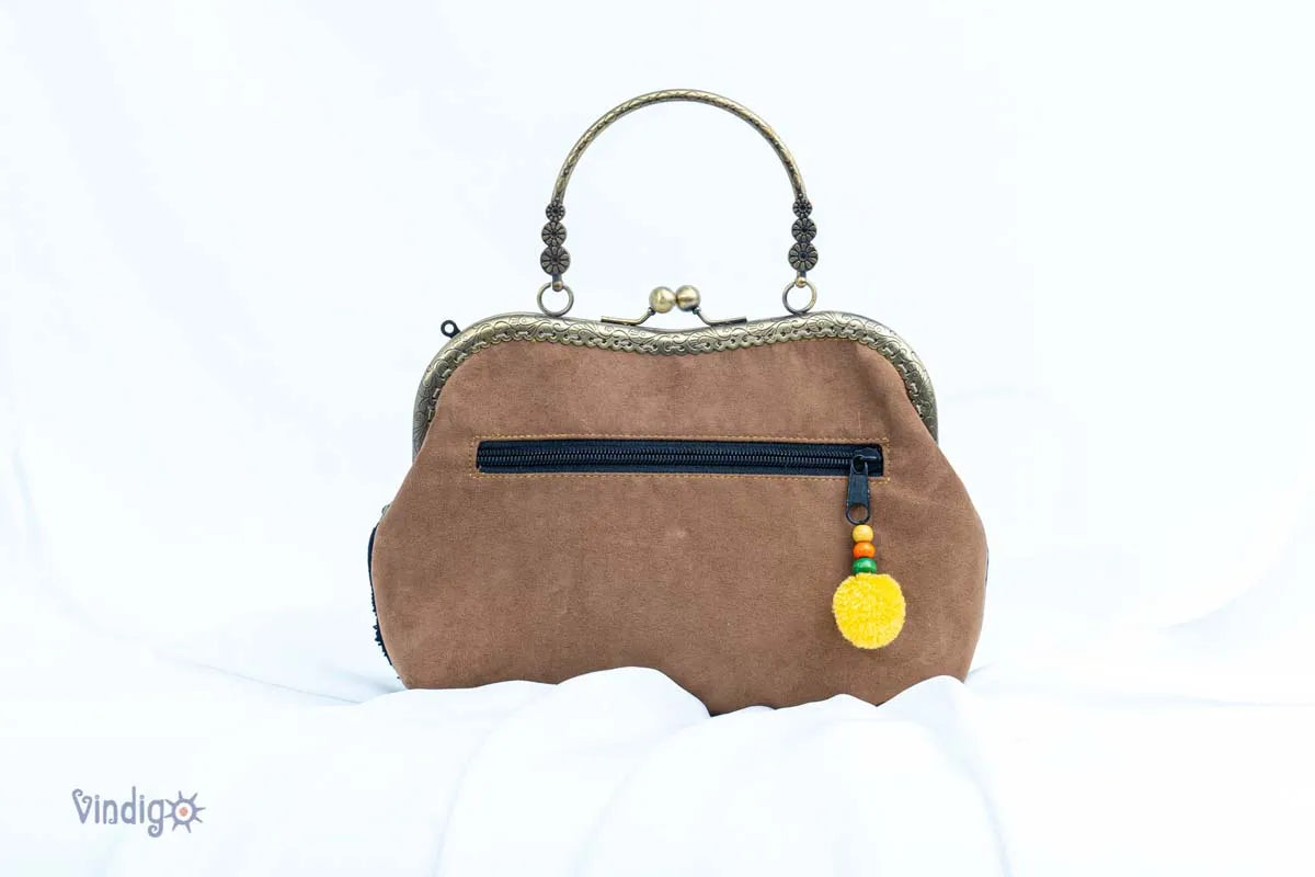 Back view of handbag showing zipper and brown suede fabric
