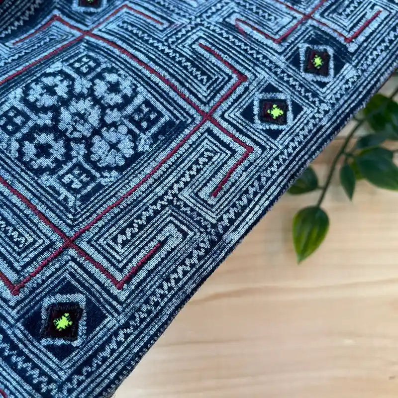 Detailed shot of embroidery on indigo hemp pouch bag