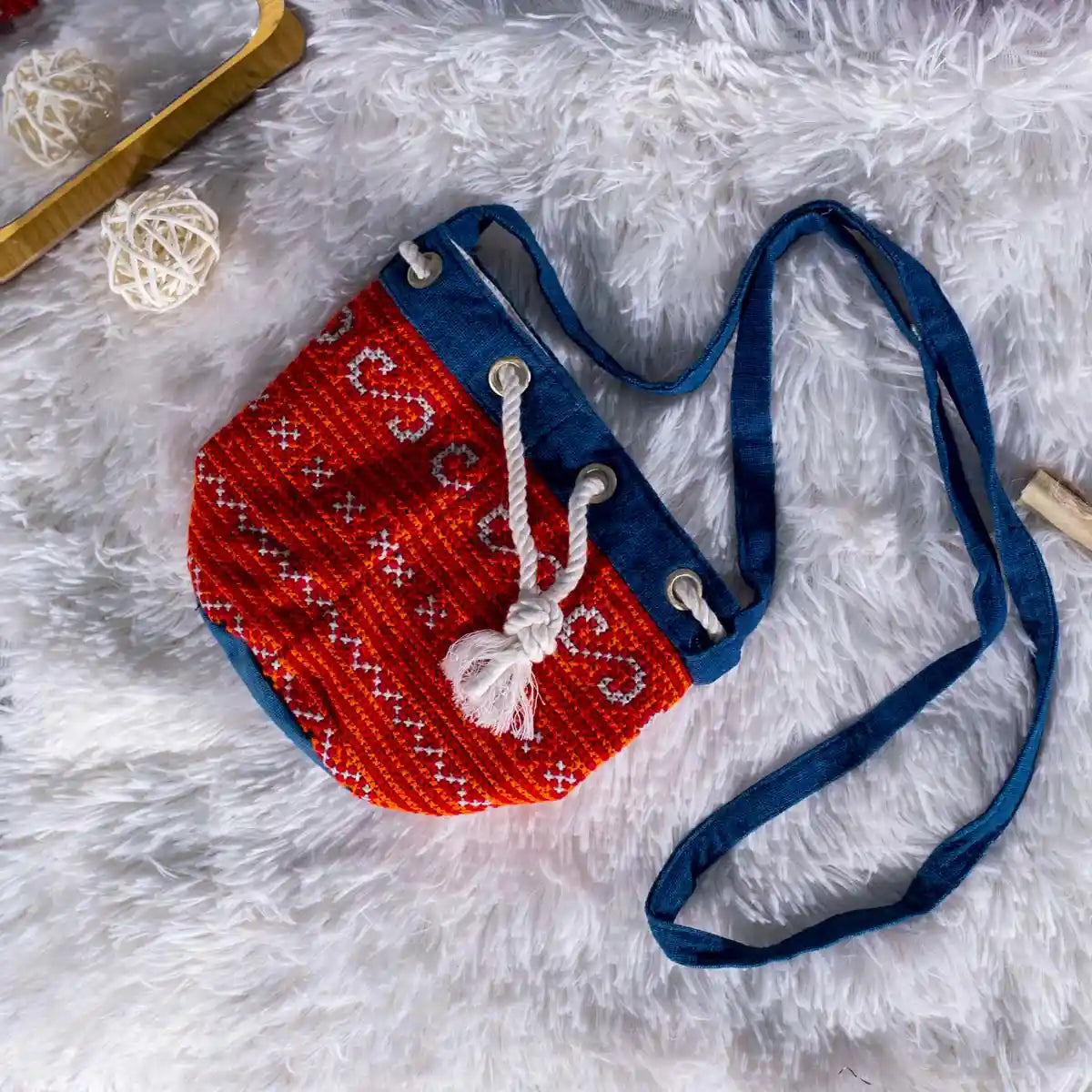 Vindigo red indigo hemp embroidery bag on soft fabric surface