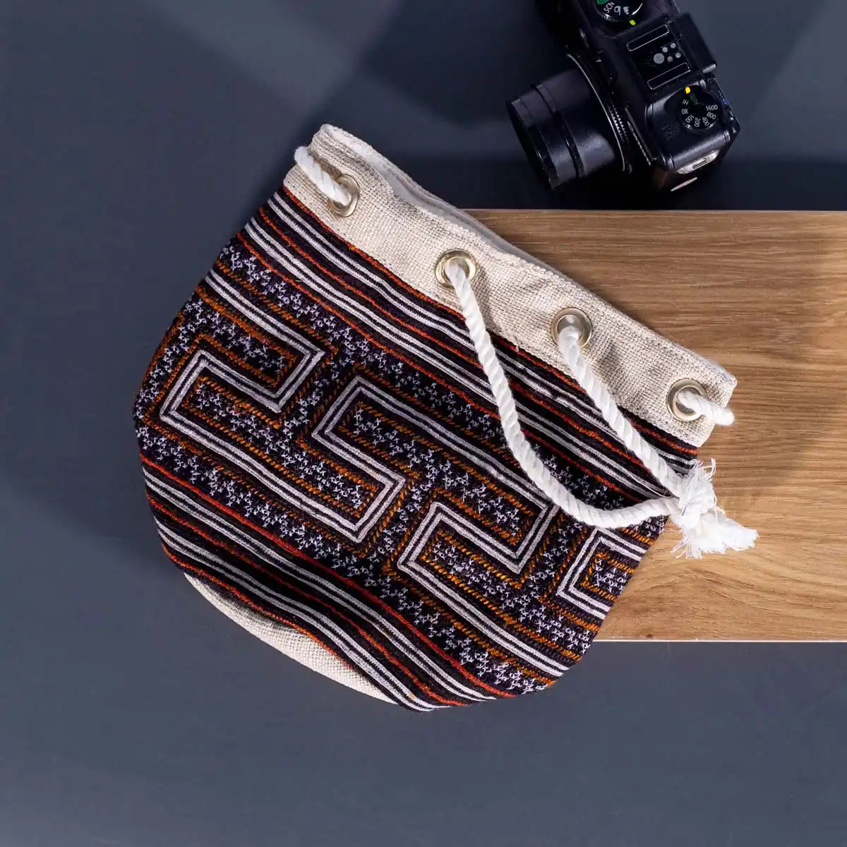 Vindigo brown embroidered canvas bucket bag flat angle view