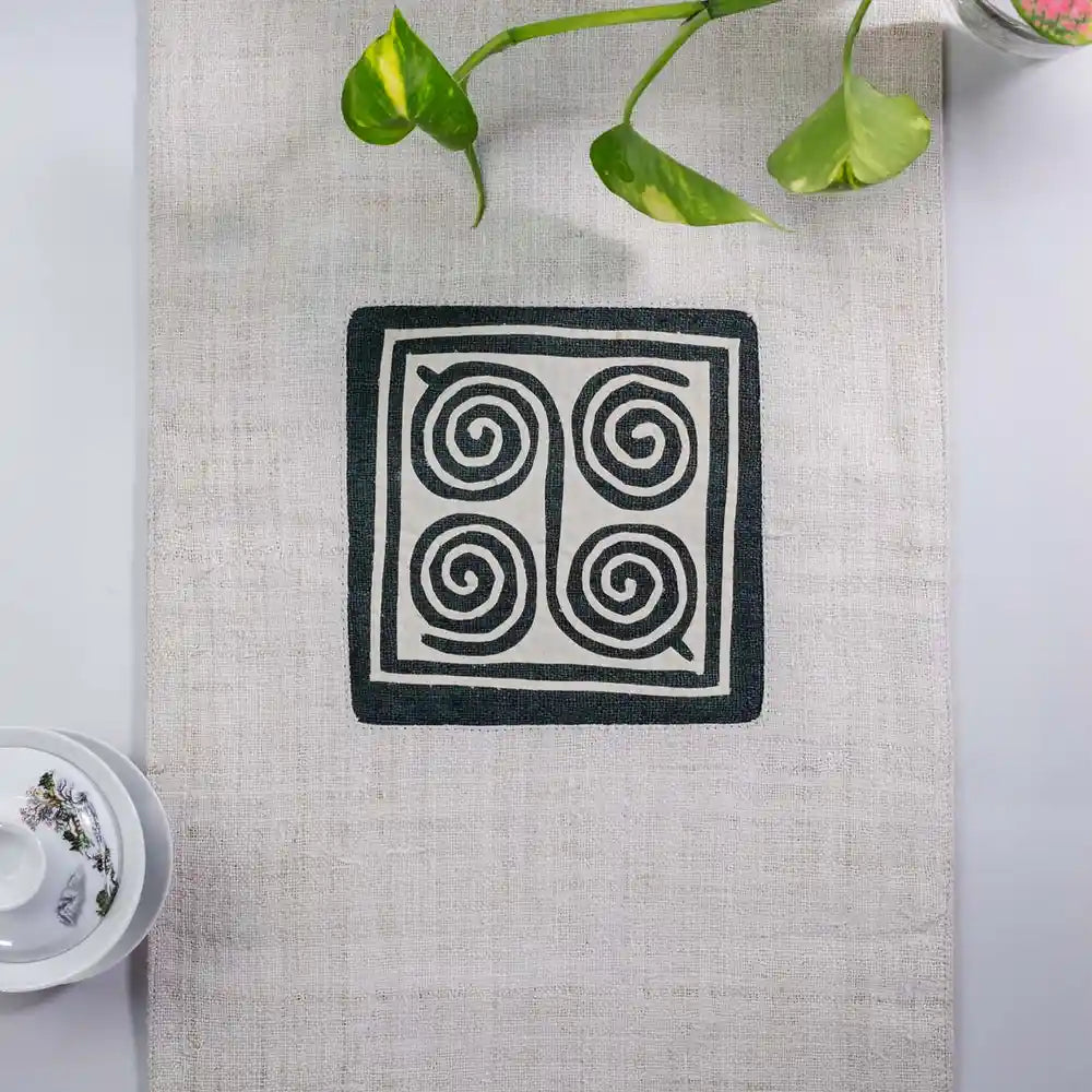 Vindigo beige hemp table runner center view highlighting traditional H’mong spiral