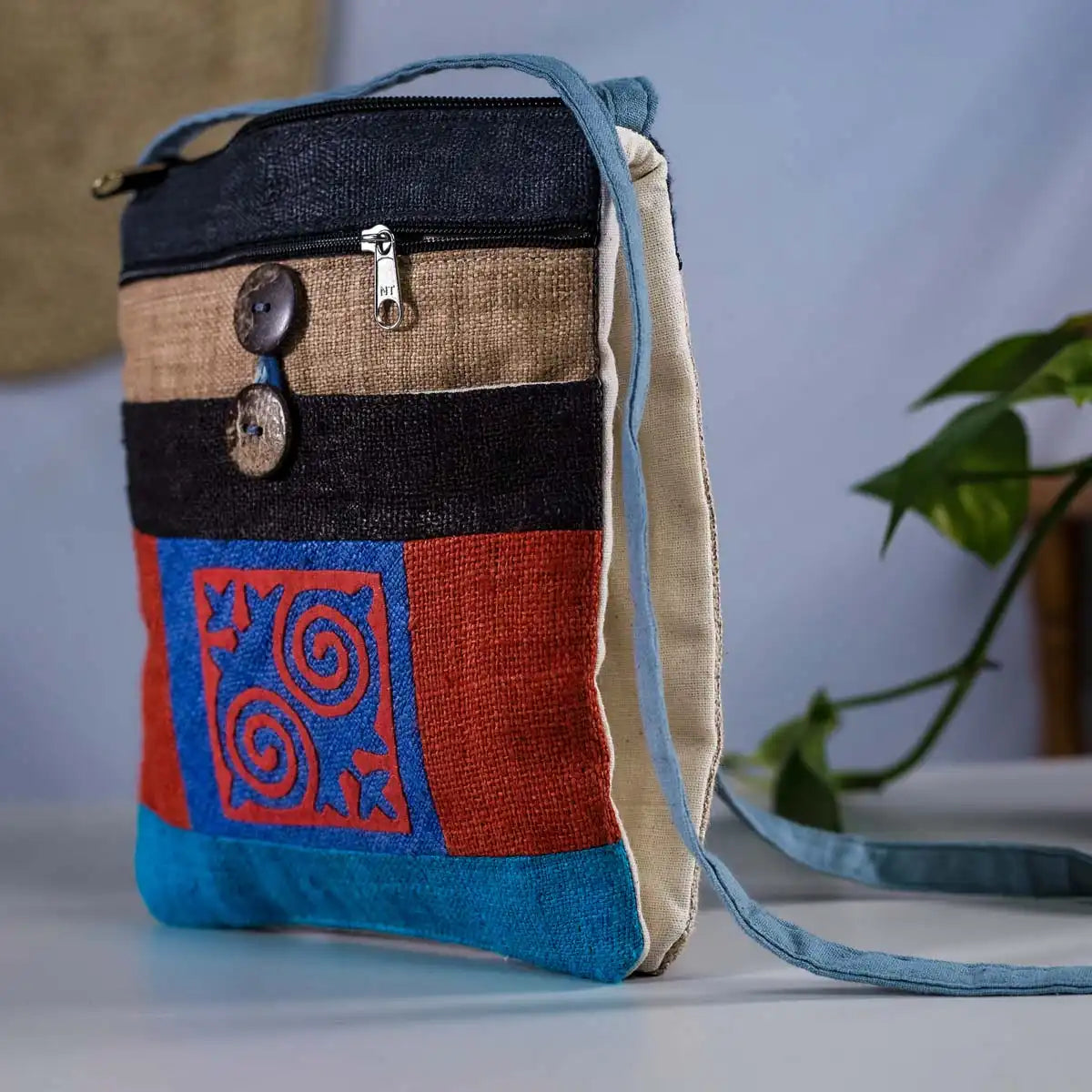 Vindigo red and blue hemp crossbody bag with coconut button closure