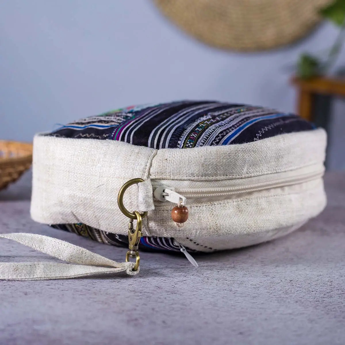 Vindigo hemp cosmetic bag side view with beige strap and woven stripe detail