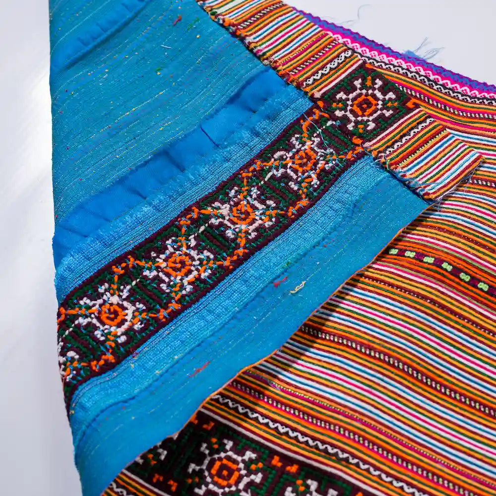 Vindigo orange and blue cotton fabric with floral border close-up detail