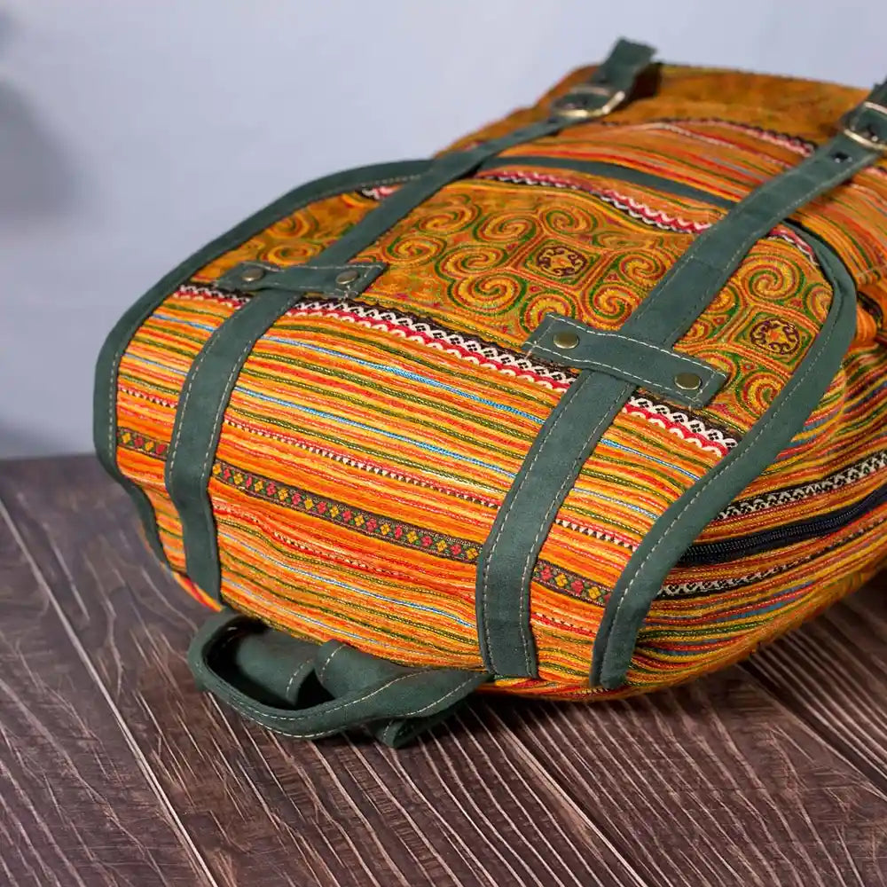 Vindigo yellow embroidered cotton backpack angled view