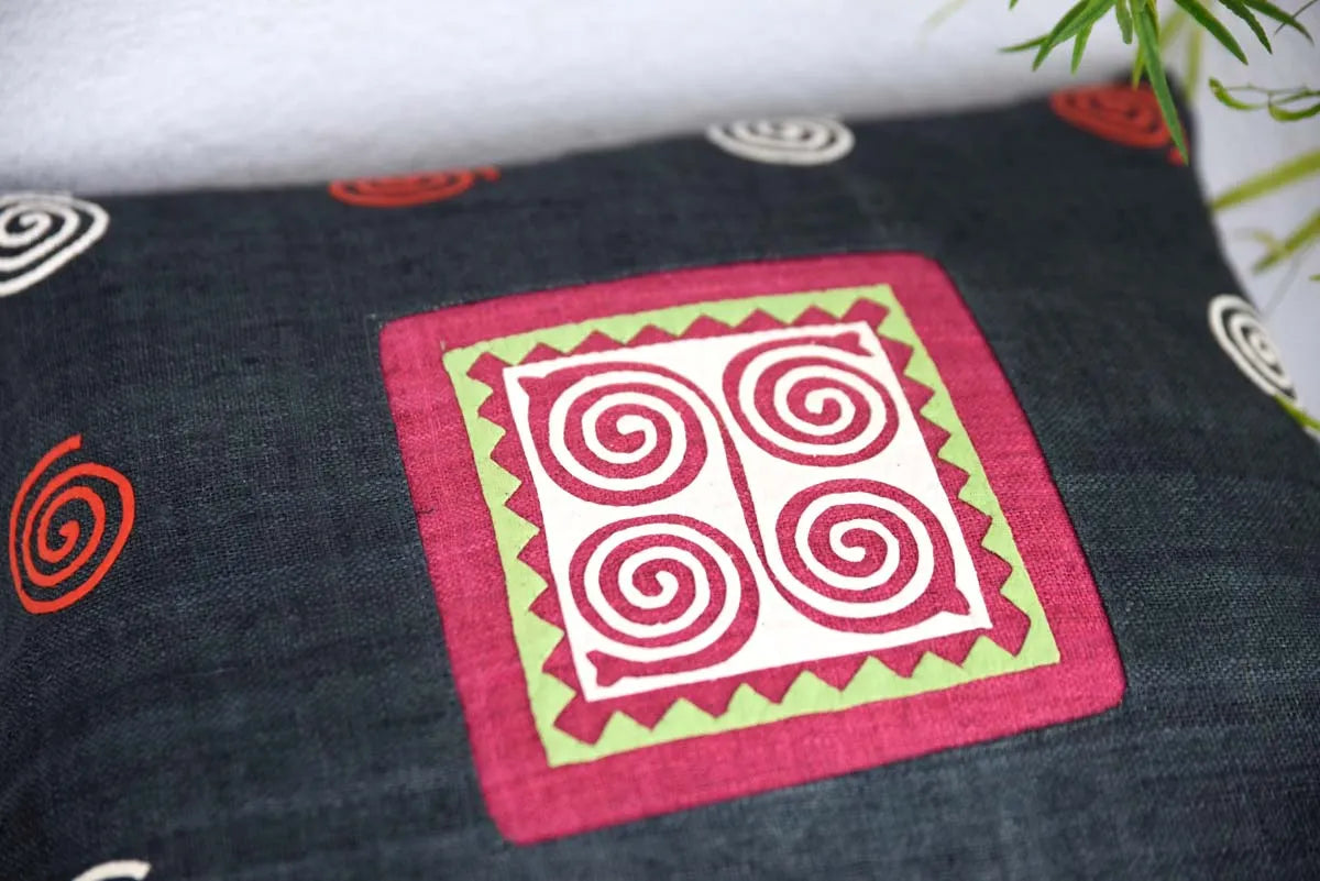 Close-up of pink spiral patch with zigzag border on hemp fabric