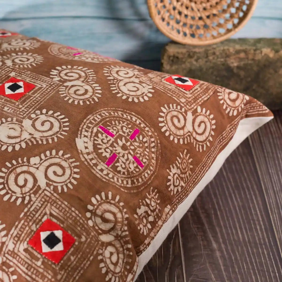 Vindigo brown batik cushion cover styled on sofa with wicker decor