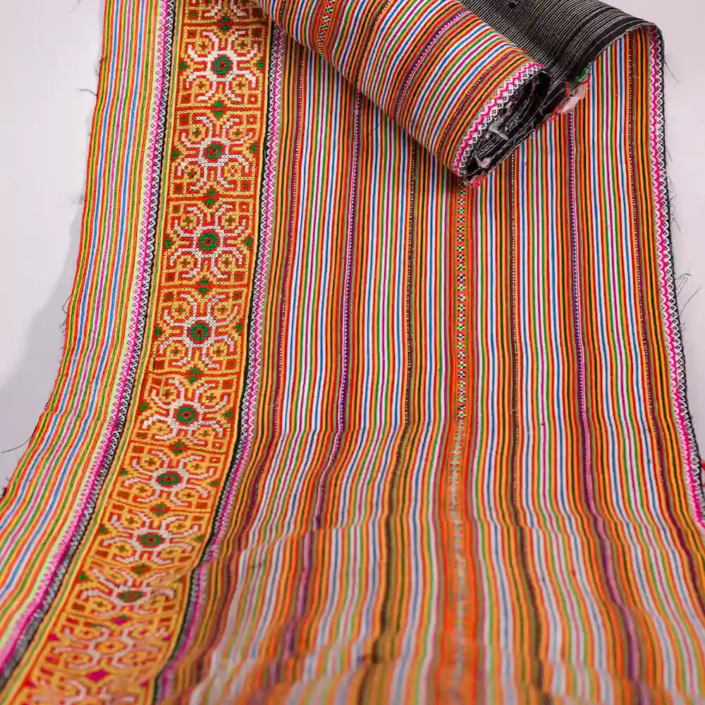 Vindigo orange cotton fabric roll showing embroidery and stripe pattern
