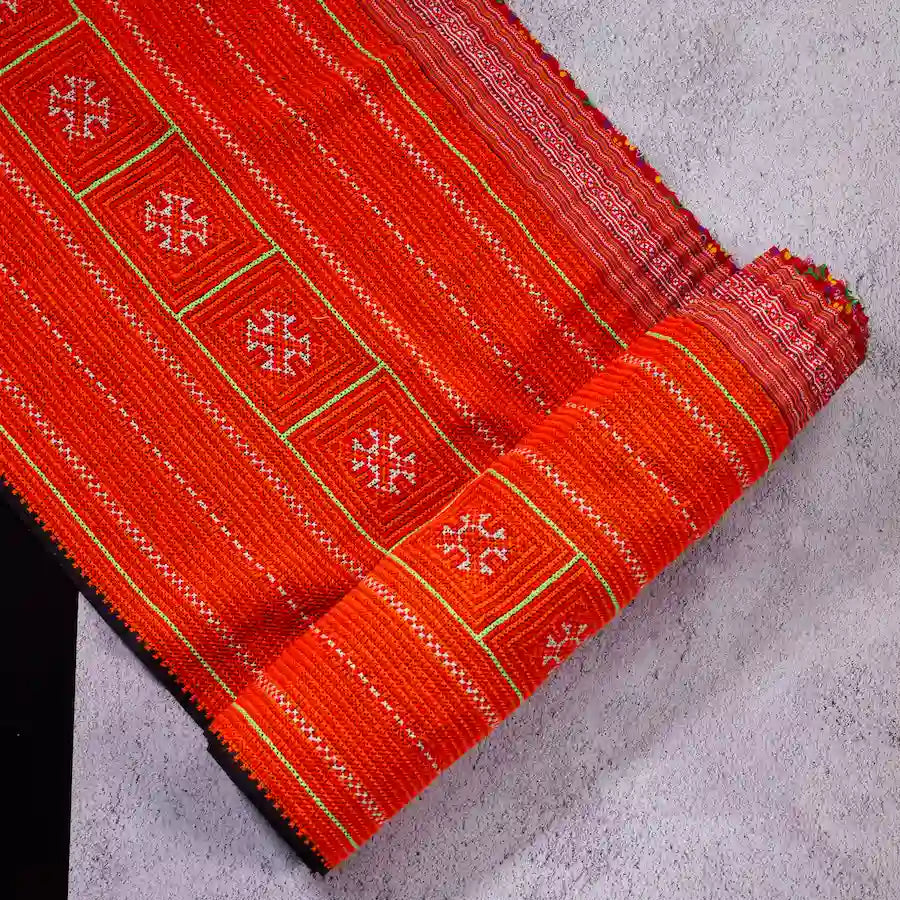 Vindigo red hemp tribal embroidered fabric roll close-up detail