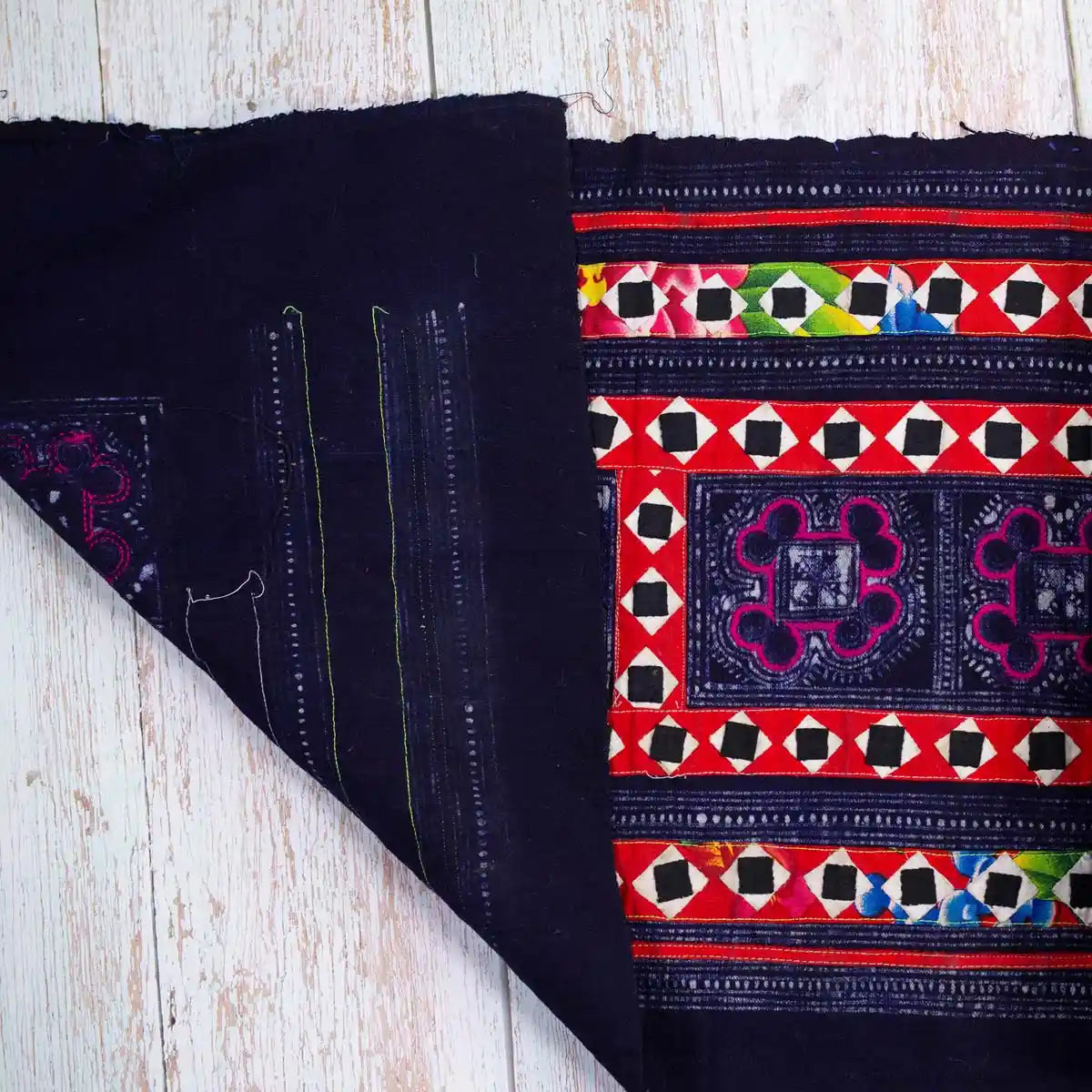 Vindigo black tribal embroidered fabric roll folded corner view