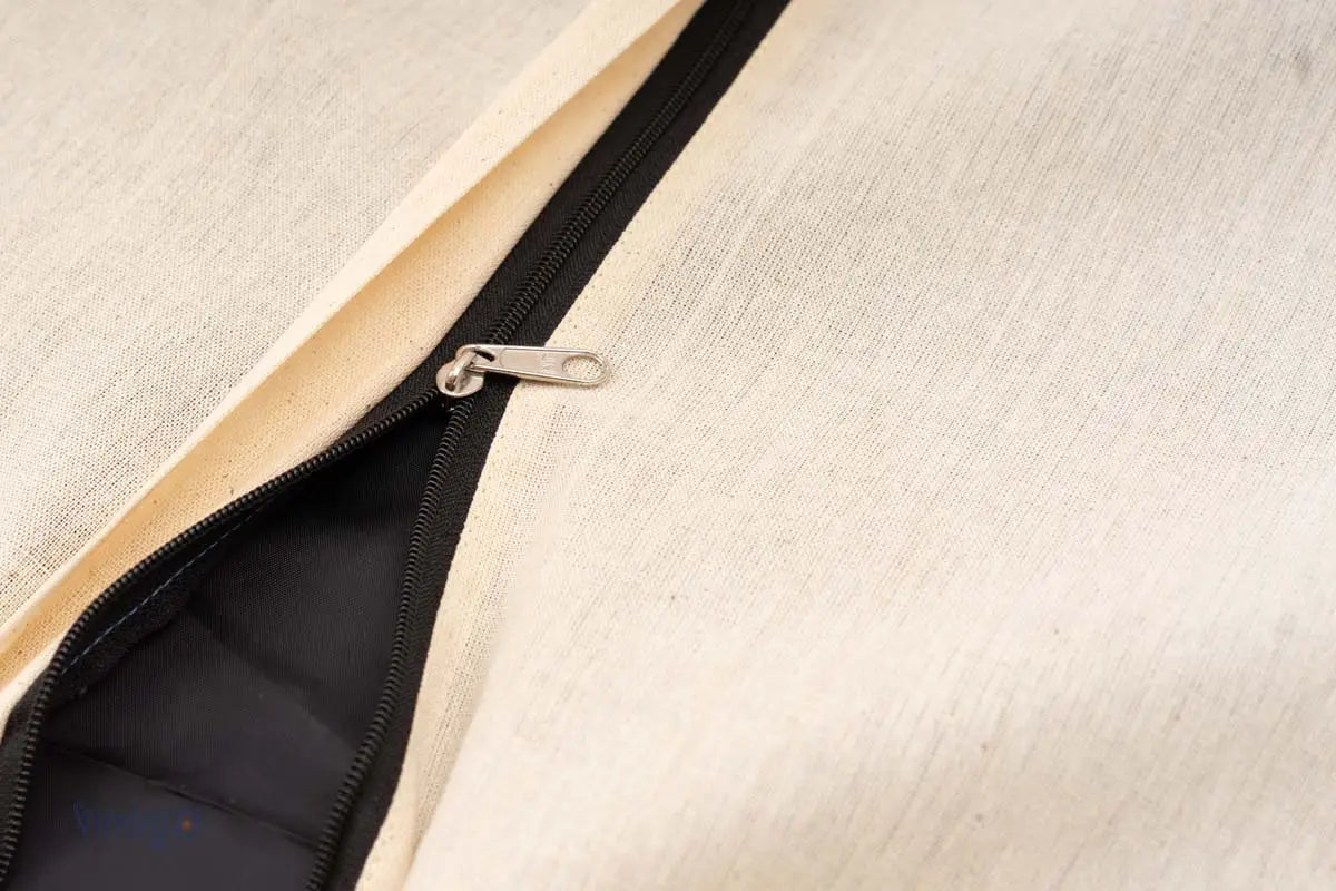 Close-up of black zipper on natural cotton cushion back panel
