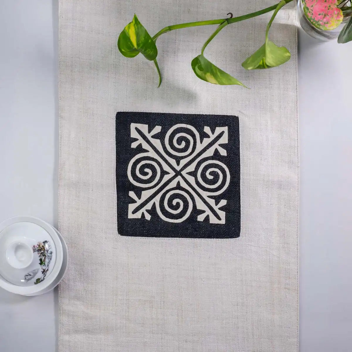 Vindigo beige hemp table runner close-up showing detailed geometric H’mong stitching