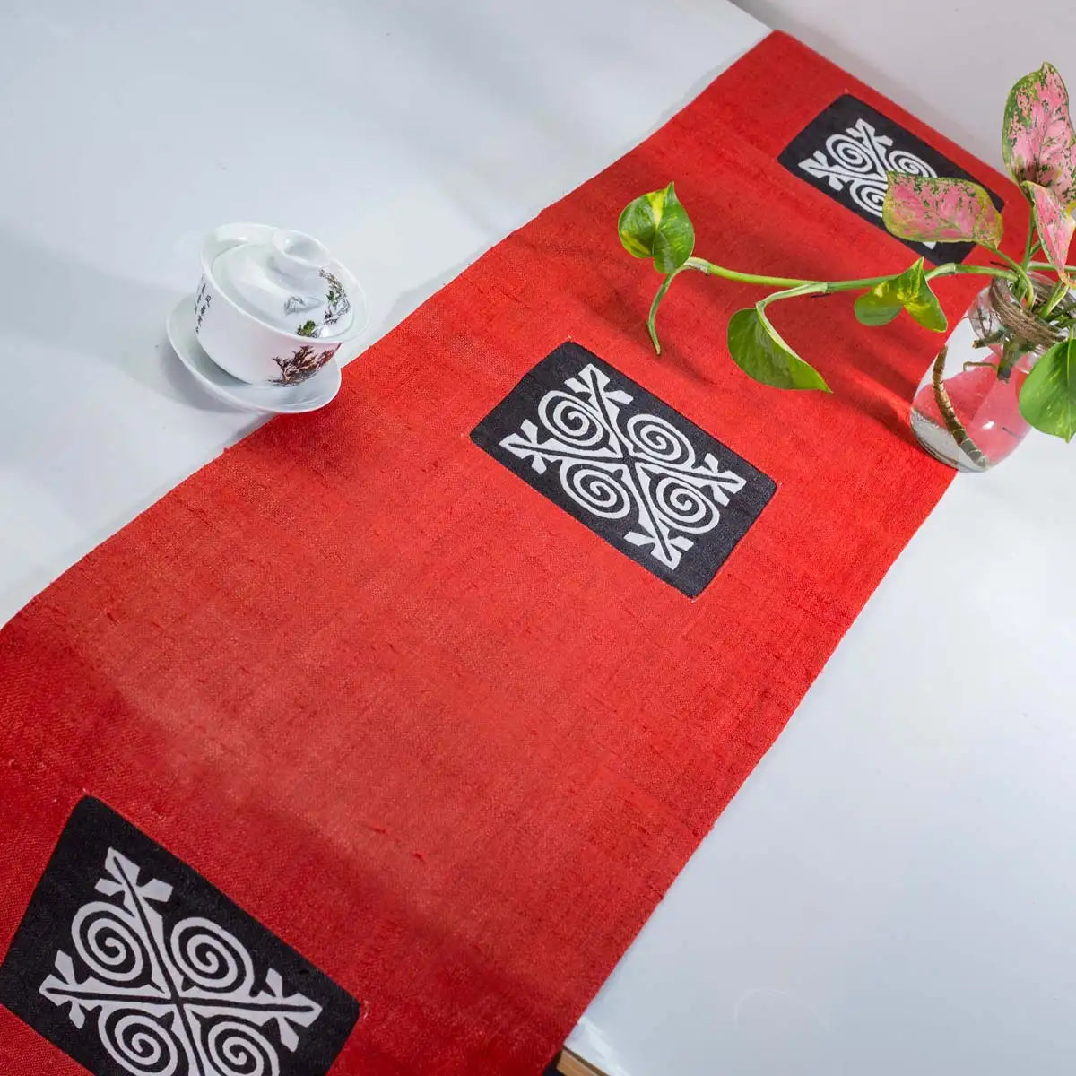 Vindigo red hemp table runner angled view displaying traditional H’mong textile art
