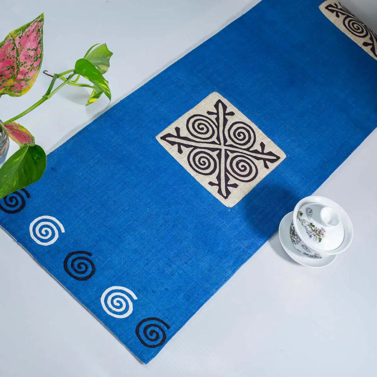 Vindigo blue hemp table runner angled view highlighting handmade cotton applique
