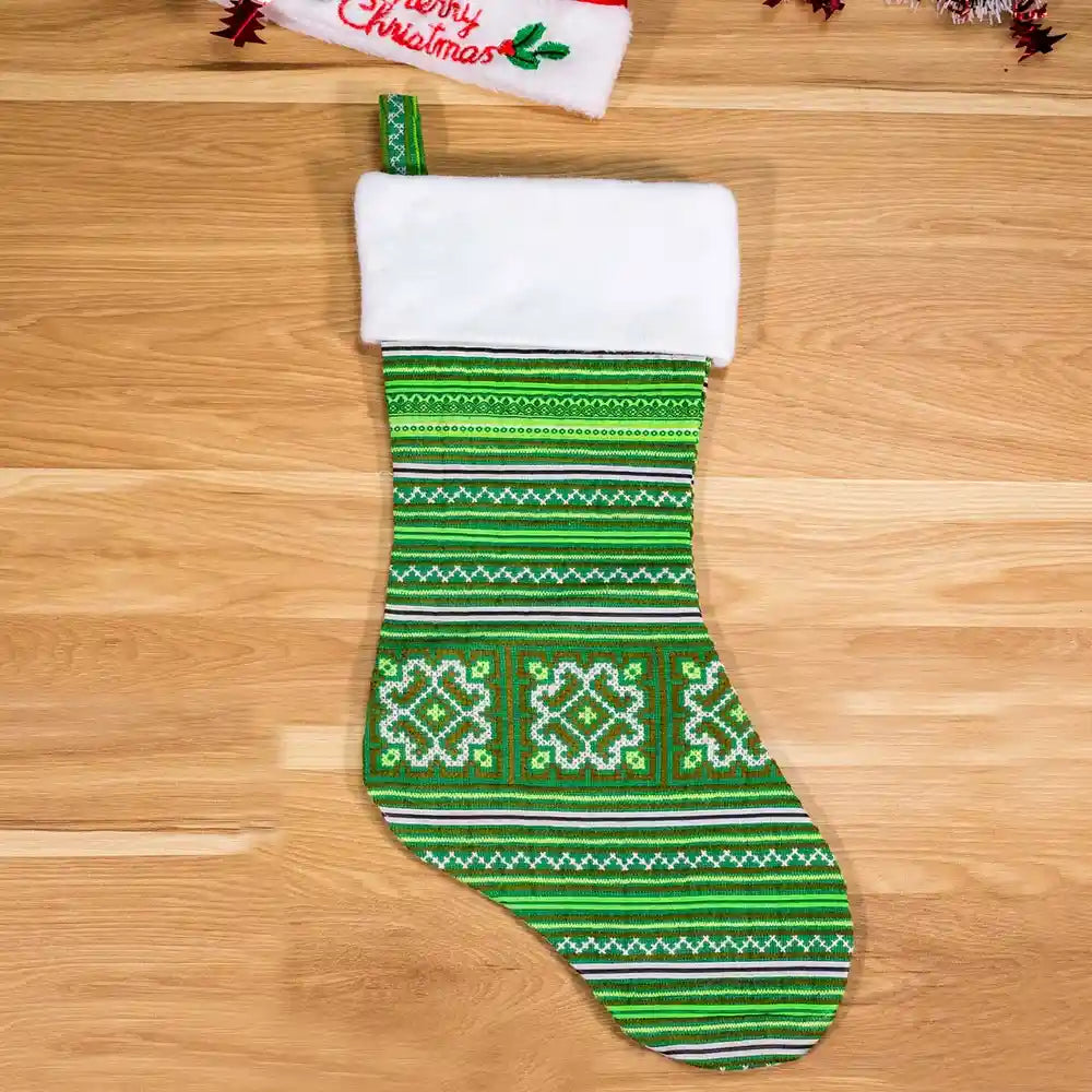 Vindigo green tribal embroidery Christmas stocking wooden background front view